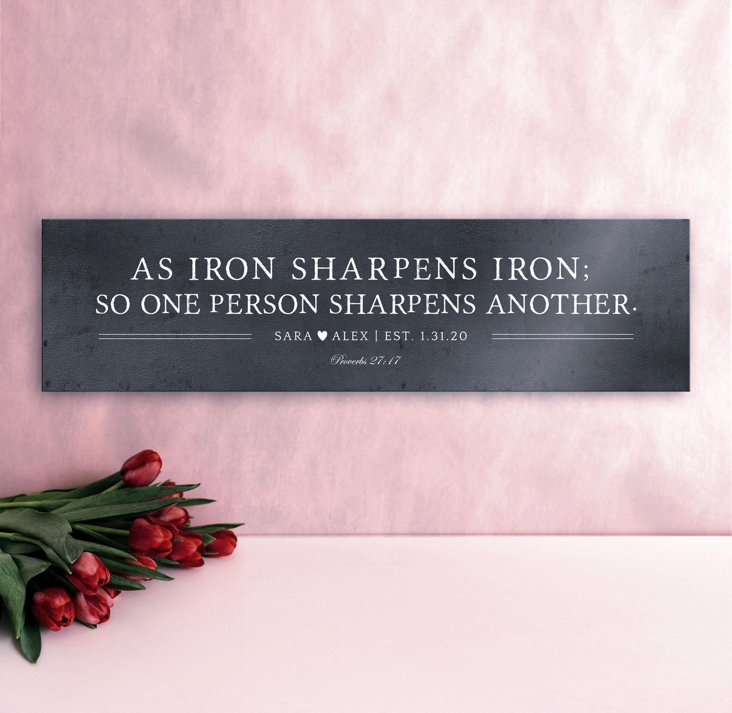 As iron sharpens iron so one person sharpens another is inscribed on a wide format metal plaque and the names Sara and Alex and their union date is under the bible verse. Photo courtesy of Honeycomb Proverbs