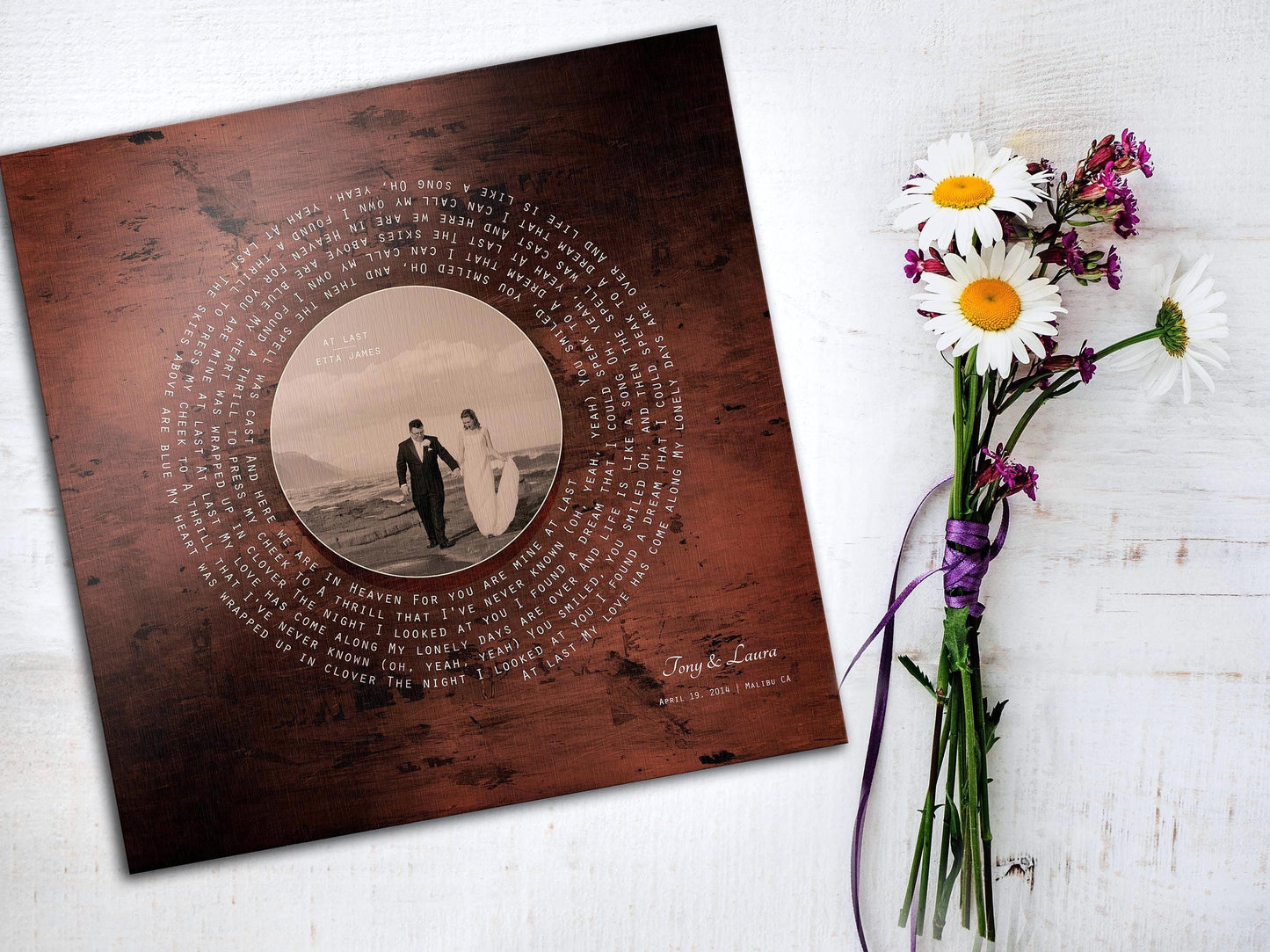 Custom bronze personalized anniversary gift decor. A portrait plaque with a song record theme featuring song lyrics around a circular photo. The photo is the record label and the lyrics spiral around the photo to create the illusion of a vinyl record