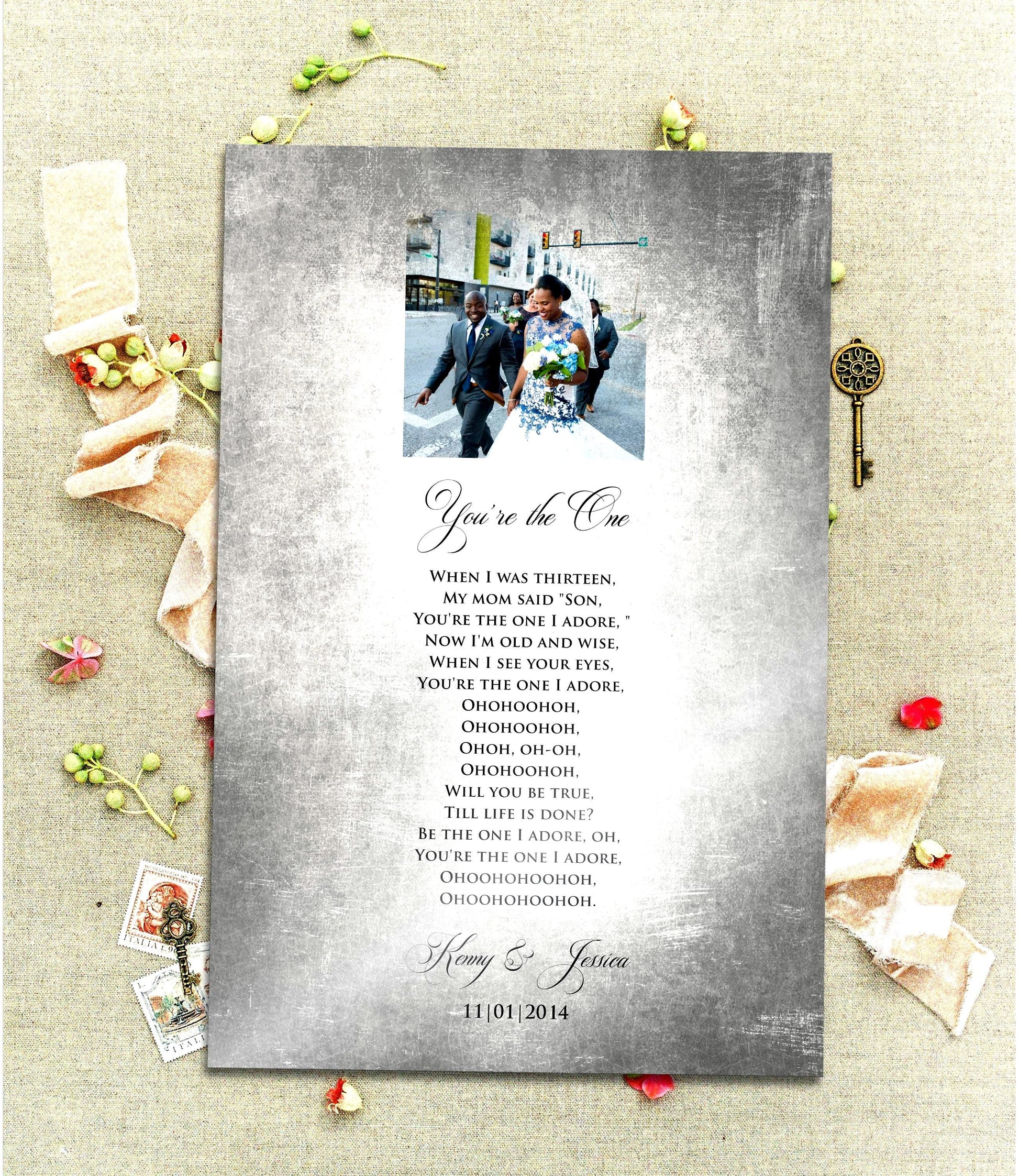 A Vintage, Custom Tin Portrait with song plaque is laid on a linen cloth with sprigs of poppies and brass antique keys. The Tin plaque is tarnished and aged for a vintage styling and features a cameo photo motif at the top of the plate and song lyrics, names and wedding date below. The song title and the couple's names are inscribed with elegant and romantic scripted lettering.

Photo Courtesy of Honeycomb Proverbs